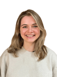 A photo of Lucy who has medium-length blonde hair and is wearing a cream jumper, smiling.