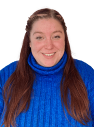 A photo of Hayley, she is wearing a blue turtleneck and has long reddish brown hair